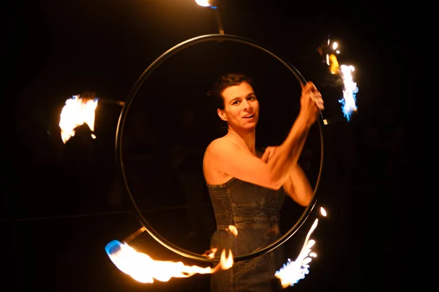 A fire hoop framing its performer