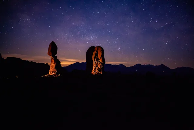 Balanced Rock beneath a violet night sky