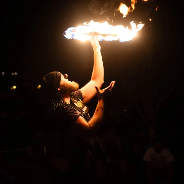 Fire balanced above an upturned face