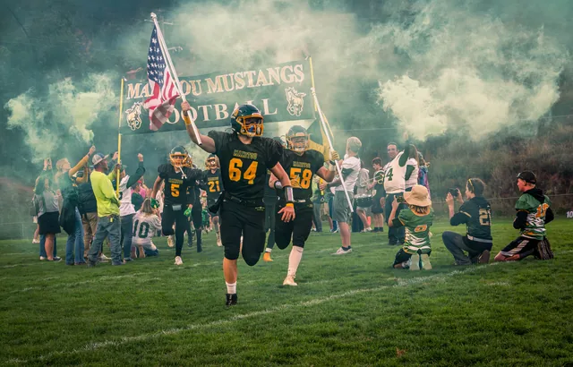 Football team emerging through smoke