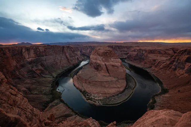 Horseshoe Bend beneath a stormy sunset
