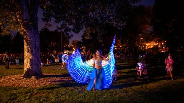 Illuminated wings beneath a twilight tree