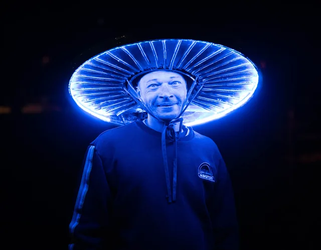 Portrait beneath an electric blue halo